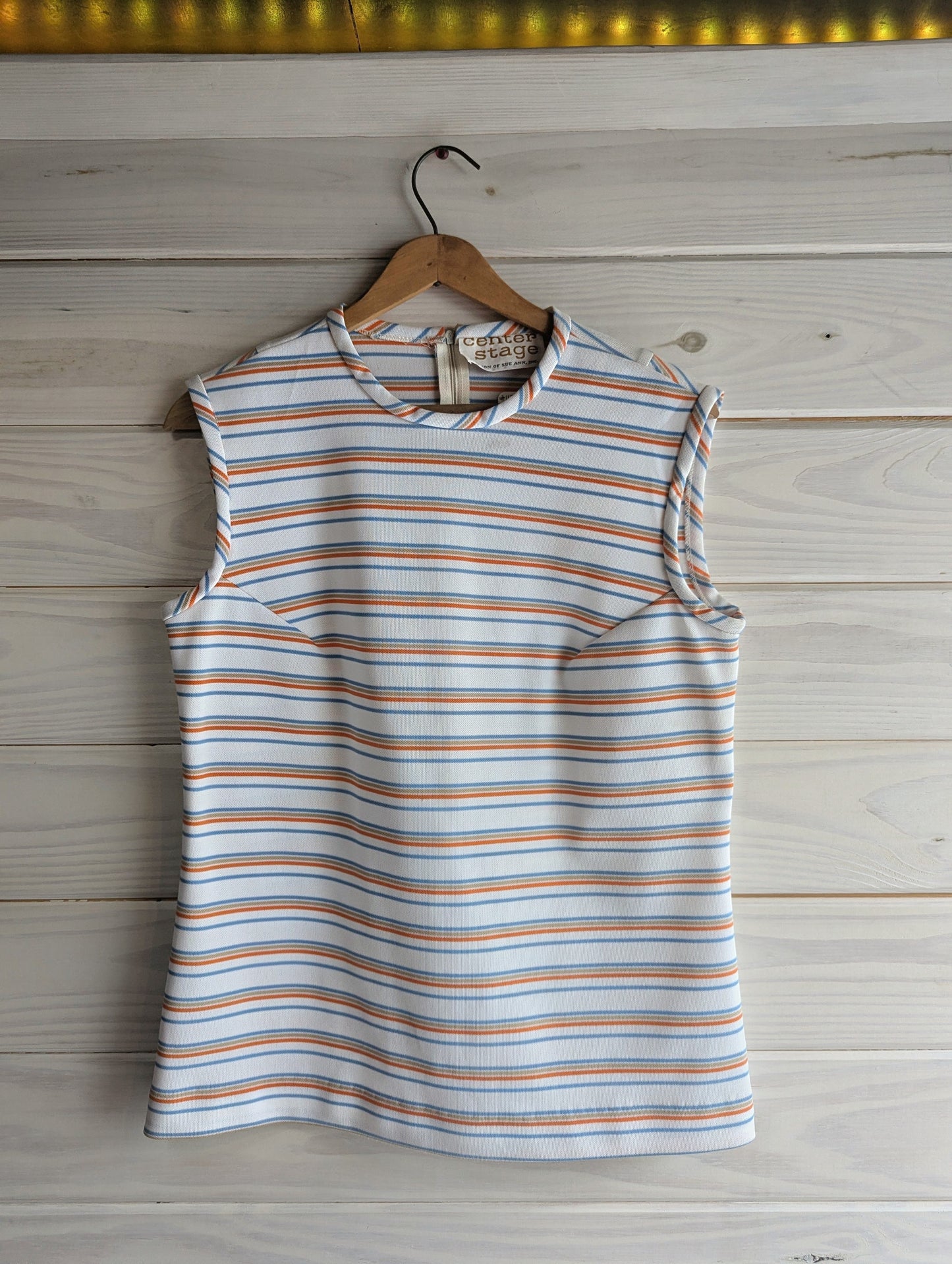 1970's Center Stage striped sleeveless top in white, blue, orange and beige front view. 
