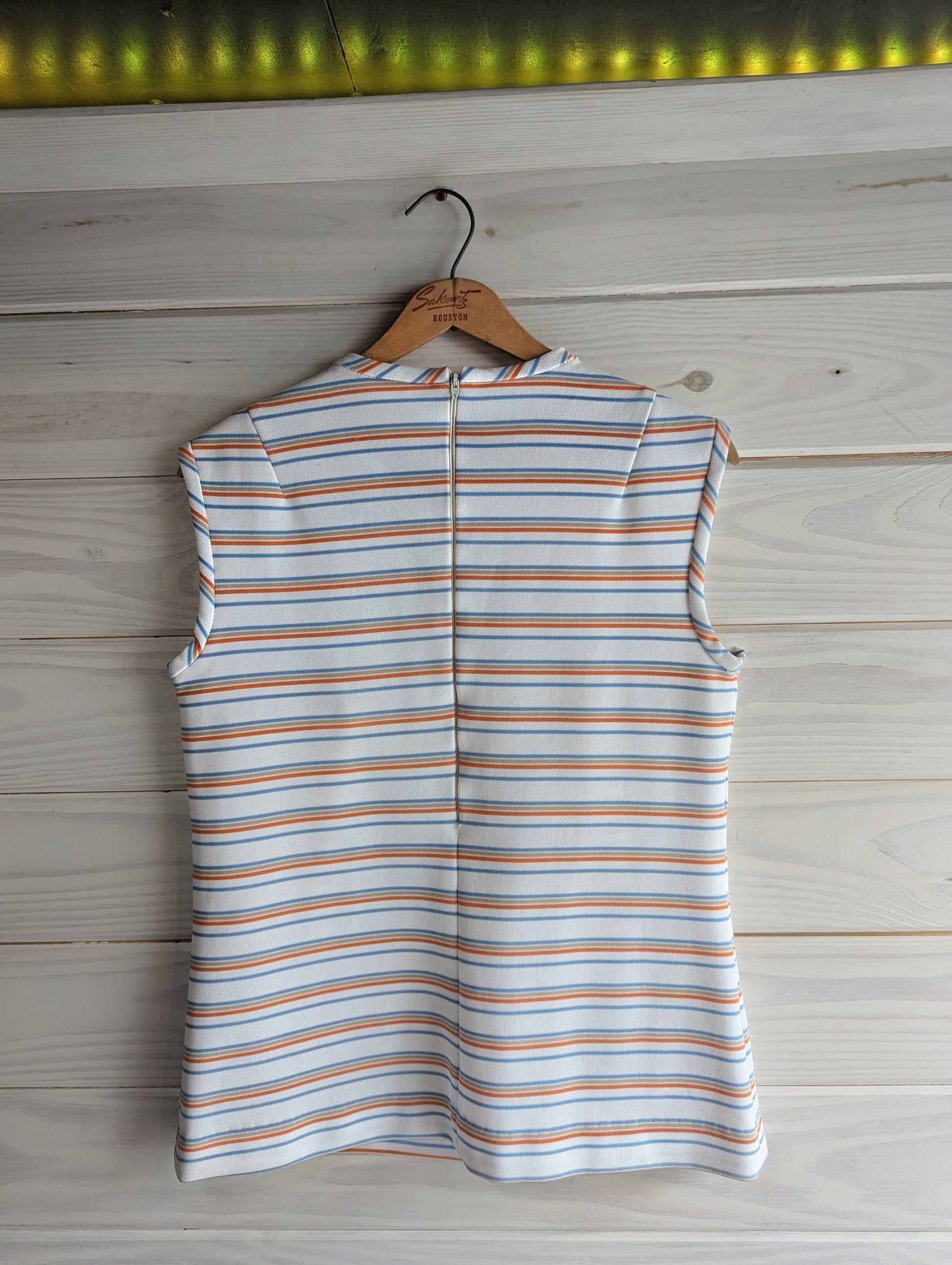 1970's Center Stage striped sleeveless top in white, blue, orange and beige back view showing zipper from the neck to middle of back. 